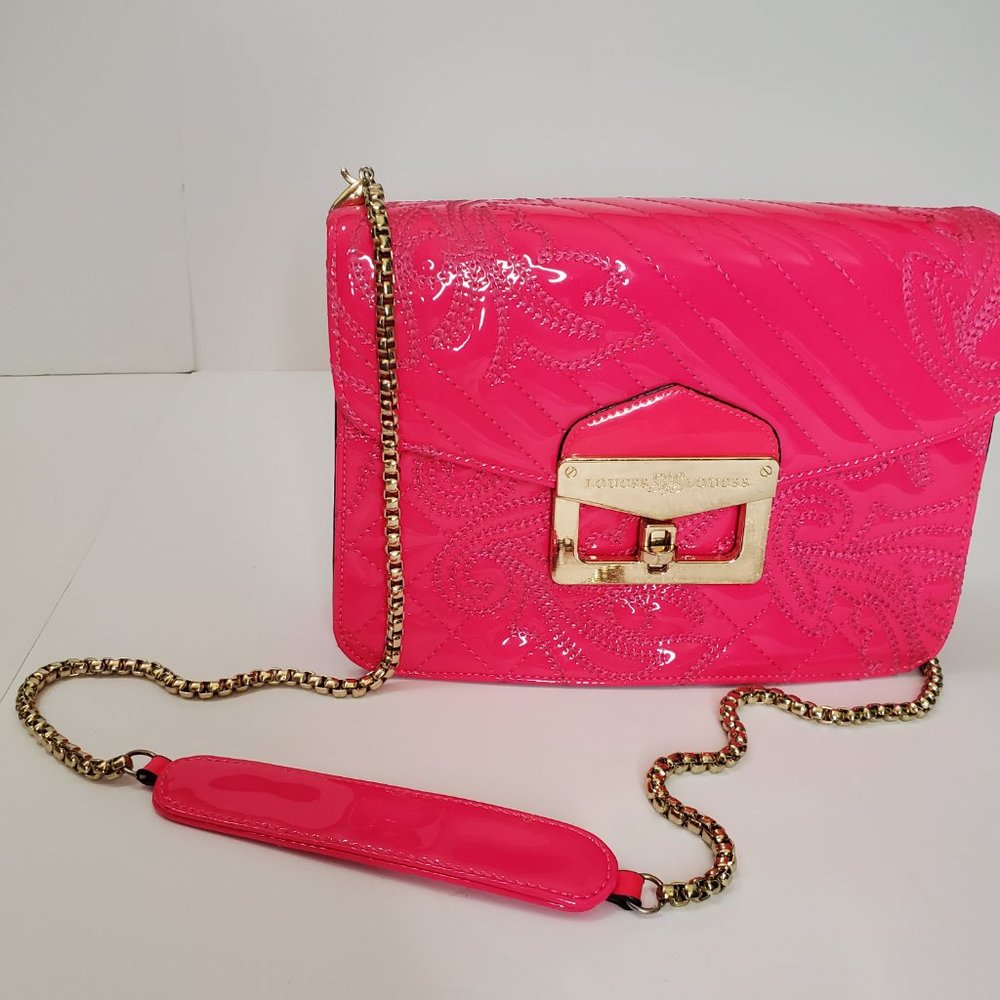 Hot pink patent leather bag with gold details.